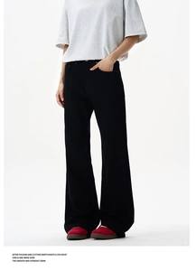 Detail of high street black flared pants featuring rivets and heavy fabric texture