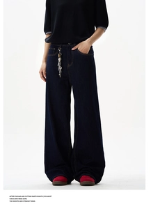 Close-up of high-waisted dark blue wide-leg denim jeans with orange topstitching details