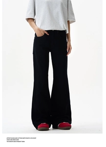 Detail view of black high-waisted flared trousers with premium stitching and retro style