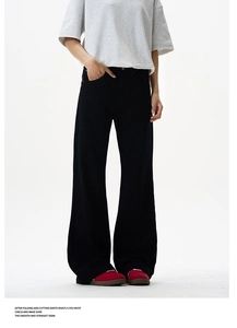 Close-up of black high-waisted wide-leg trousers with sleek draping and straight silhouette