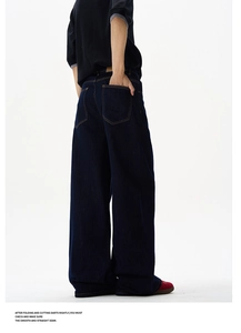 Detailed back view of vintage wash black jeans featuring large pockets and wide leg cut