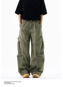 Detail of army green cargo pants featuring wide-leg cut and 3D pleated knee design