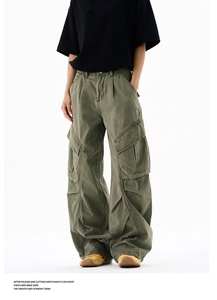 Detail showing the vintage olive cargo pants with 3D knee pleats and large side pockets