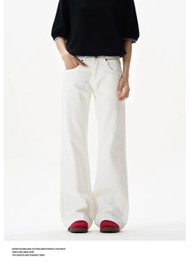 Detail of white high-waisted flared trousers with rivet design and wide-leg silhouette