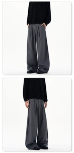 Detailed front and side view of deep grey baggy pleated trousers with high drape finish