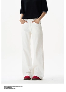 Close-up of white high-waisted wide-leg trousers with front pockets and stiff fabric