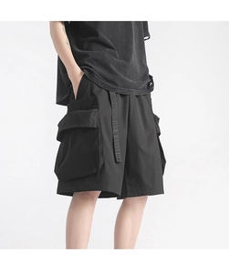 Detail view of techwear cargo shorts featuring side pockets and adjustable strap