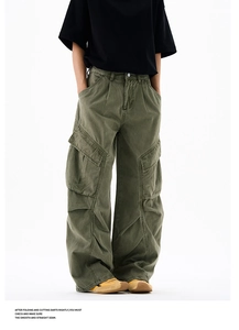 Detailed macro view of army green cargo pants with multiple pockets and pleated knees