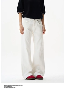 Detailed macro shot of white wide-leg trousers featuring durable cotton denim texture