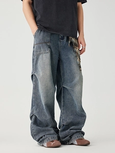 Vintage wash wide-leg denim cargo pants with distressed details and plaid accent