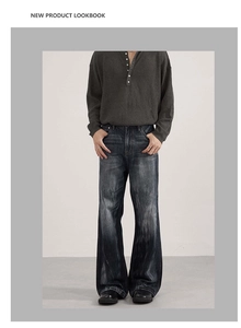 Detail of vintage washed black denim texture on cleanfit wide leg trousers for men