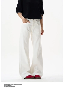 Detail of high-waist white wide-leg trousers in thick twill fabric with metal buttons