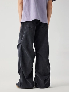 Vintage wash black wide leg cargo jeans with pleated stacks and back pocket detail