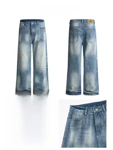 Detail display of vintage wash blue bootcut jeans showing leather logo tag and metal buttons
