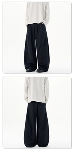 Front and back view of black minimalist wide-leg trousers with elegant pleated draping