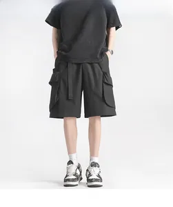 Detailed view of black cargo shorts featuring large utility pockets and a woven belt