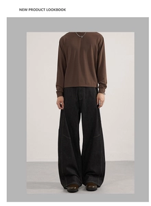 Men's retro black wide-leg denim jeans styled with a minimalist dark brown long sleeve tee