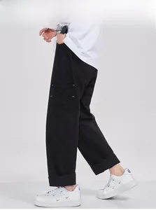 Detail showing oversized cargo pockets with white contrast stitching on black trousers