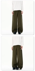 Detailansicht der olivgrünen weiten Hose mit weichem Fall und Streetwear-Stapeleffekt