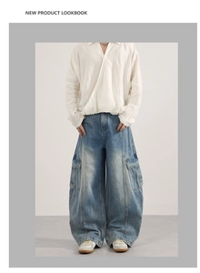 Detail of vintage washed loose-fit cargo jeans with wide-leg cut and side utility pockets