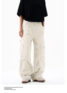 Detail showing high-quality stitching on side cargo pockets of beige workwear trousers