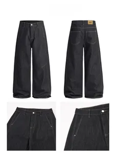 Detail view of high-waist denim jeans with contrast stitching and leather brand tag