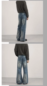 Detail of light blue washed flare jeans showing the vintage denim texture and fit