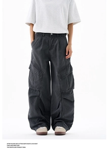 Detail of dark grey washed cargo pants showing oversized pockets and stacked cuffs
