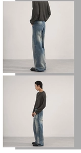 Detail view of retro washed blue wide-leg jeans with vintage distressed textures and fading