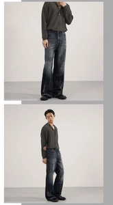 Detail of heavy washed distressed denim jeans with vintage whiskers and wide leg fit