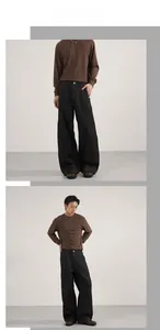 Detail of black wide-leg denim jeans with unique curved contrast stitching and brown top