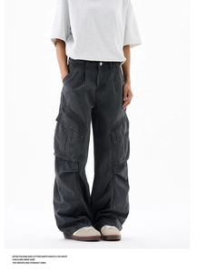 Detailed view of grey wide-leg cargo pants with distressed wash and functional side pockets