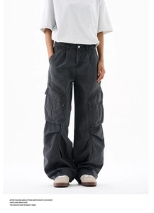 Detailed view of the distressed washed fabric and large cargo pockets on the trousers
