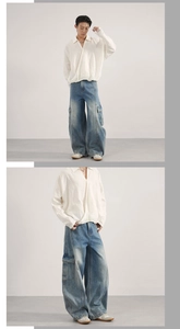 Detail of oversized washed blue utility cargo jeans with wide-leg cut and side pockets