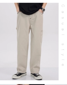 Detail view of khaki cargo pants with large side pockets and durable cotton fabric