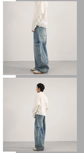 Detail of light blue washed cargo jeans with side pockets and oversized wide-leg cut