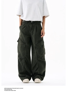 Detail of cargo pants showing deep olive green twill fabric and large side pockets