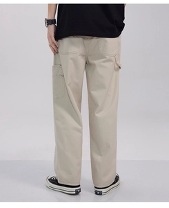 Rear view of light khaki cargo pants featuring functional back and side pockets