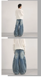 Macro shot of loose baggy denim pants featuring large utility cargo side pockets