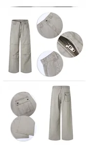 Detail view of washed gray cargo pants showing metallic zipper and back patch pocket details