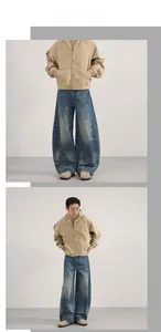 Detail of vintage men's khaki hooded work jacket and oversized wide-leg washed blue jeans