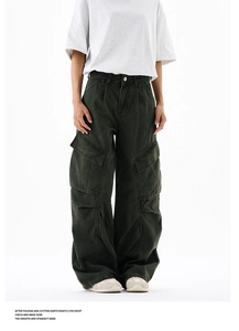 Detailed stitching on wide-leg cargo pants in dark green featuring classic side pockets