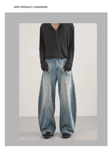 Model wearing light blue wide-leg baggy jeans with decorative seam details and washed finish