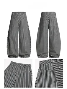 Detailed view of striped relaxed trousers showing button fly and fabric texture