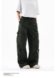 Macro detail of side cargo pockets and knee pleats on washed straight leg work trousers