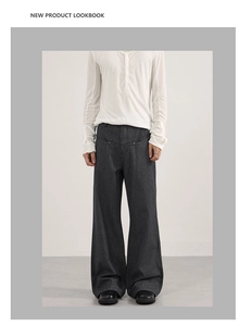 Detail of grey striped wide-leg suit trousers with vertical drape and high-waist cut