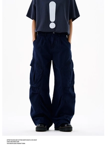 Detail of dark blue cargo pants featuring large 3D pockets and washed high street style