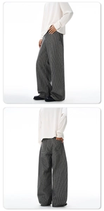 Détail du pantalon large à rayures montrant la coupe ample et le drapé fluide