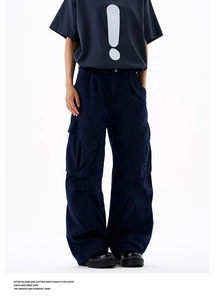Detail of dark blue cargo pants showing stitching, large side pockets and cotton texture