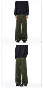 Detail of vintage washed olive cargo pants with heavy contrast stitching and multi-panel design